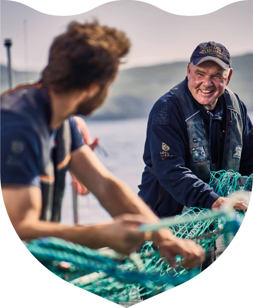 Two men working together on a salmon farm