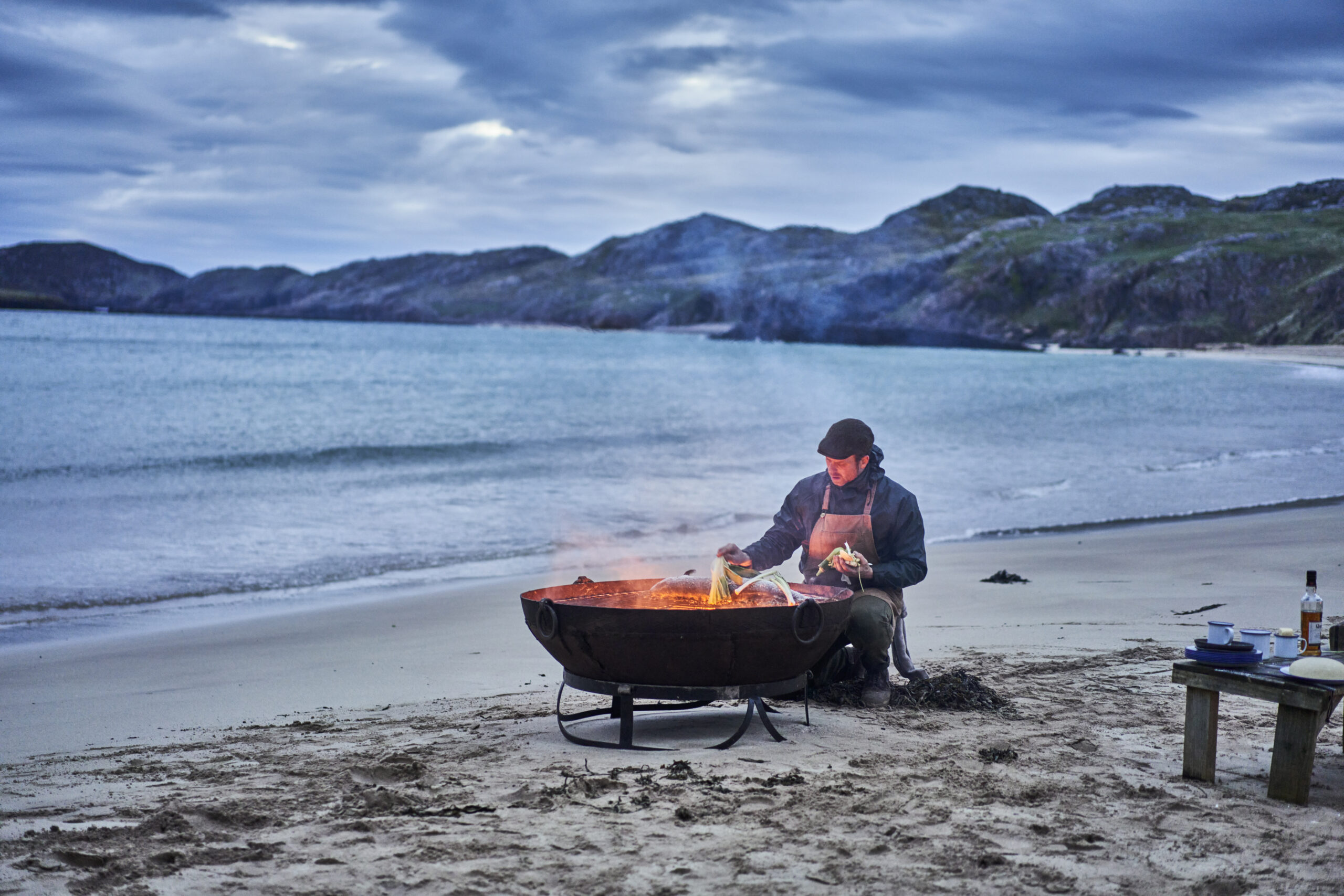 Chef Bruce Clyne-Watson cooks Loch Duart salmon on Oldshoremore beach with smoke and fire