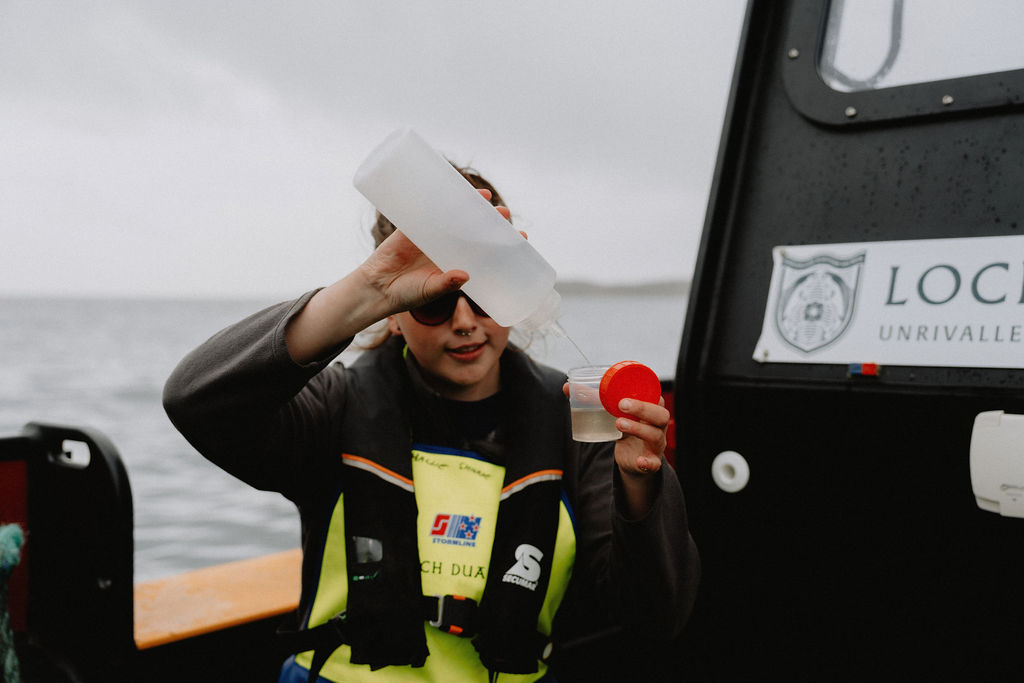 Salmon farm worker testing water