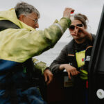 Loch Duart workers inspecting water sample on a boat