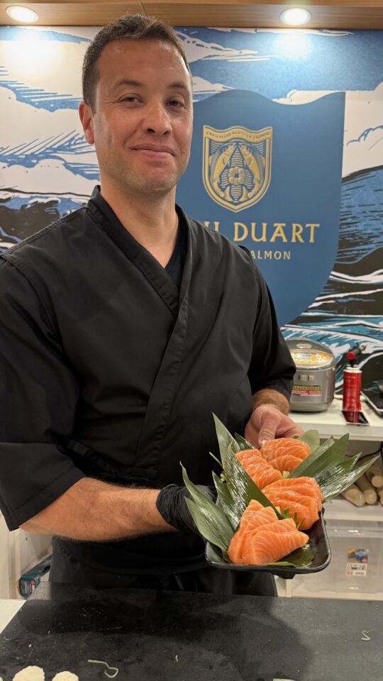 sushi chef showing plate of freshly prepared sashimi of Loch Duart Salmon